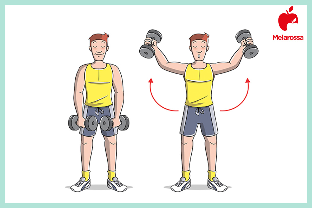 Esercizi spalle: i migliori esercizi con manubri e allenamento in palestra per spalle larghe 3 Uomo in piedi con manubri che esegue esercizi spalle facendo alzate laterali