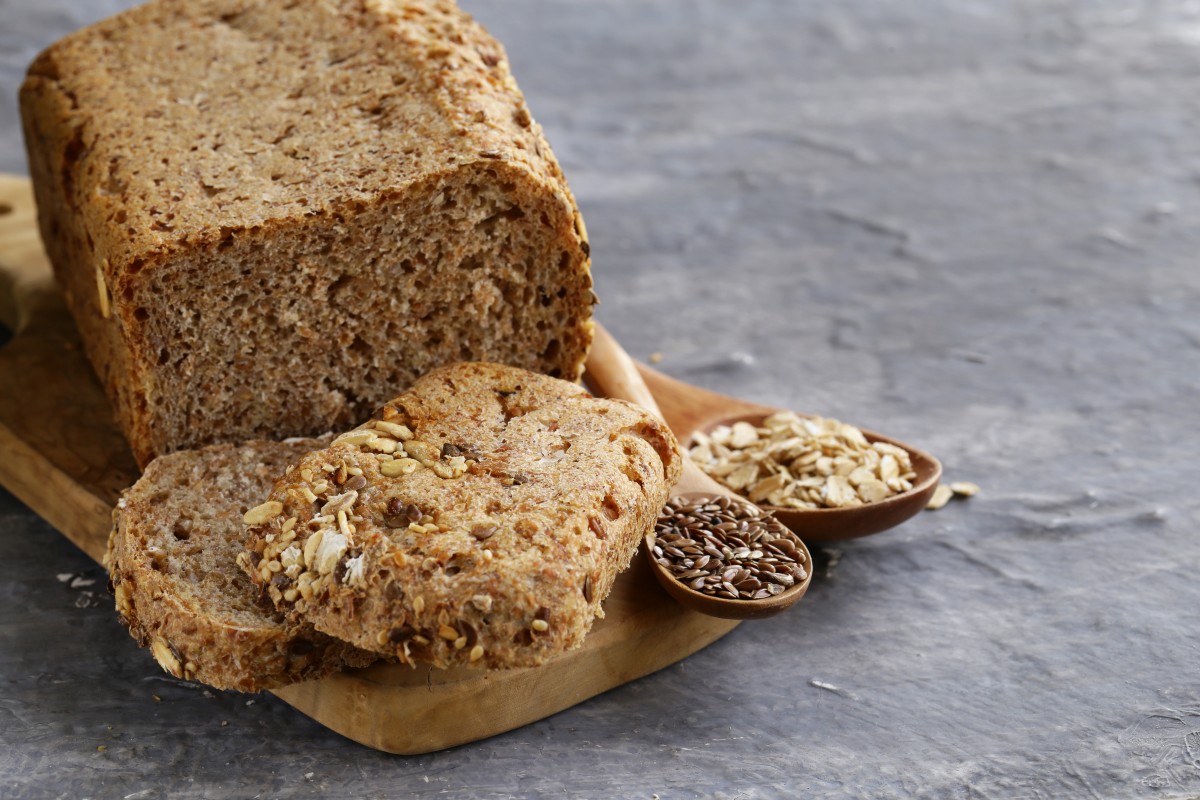 Pane fatto in casa: ricette genuine e semplici da provare 15 un pane su base di legno e due fette, mestoli con semi di cereali