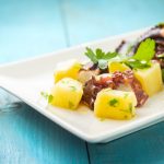 Insalata tiepida di polpo con patate: ricetta e video ricetta 1 polpo con patate: su tavolo azzurro piatto bianco con insalata di polpo con patate